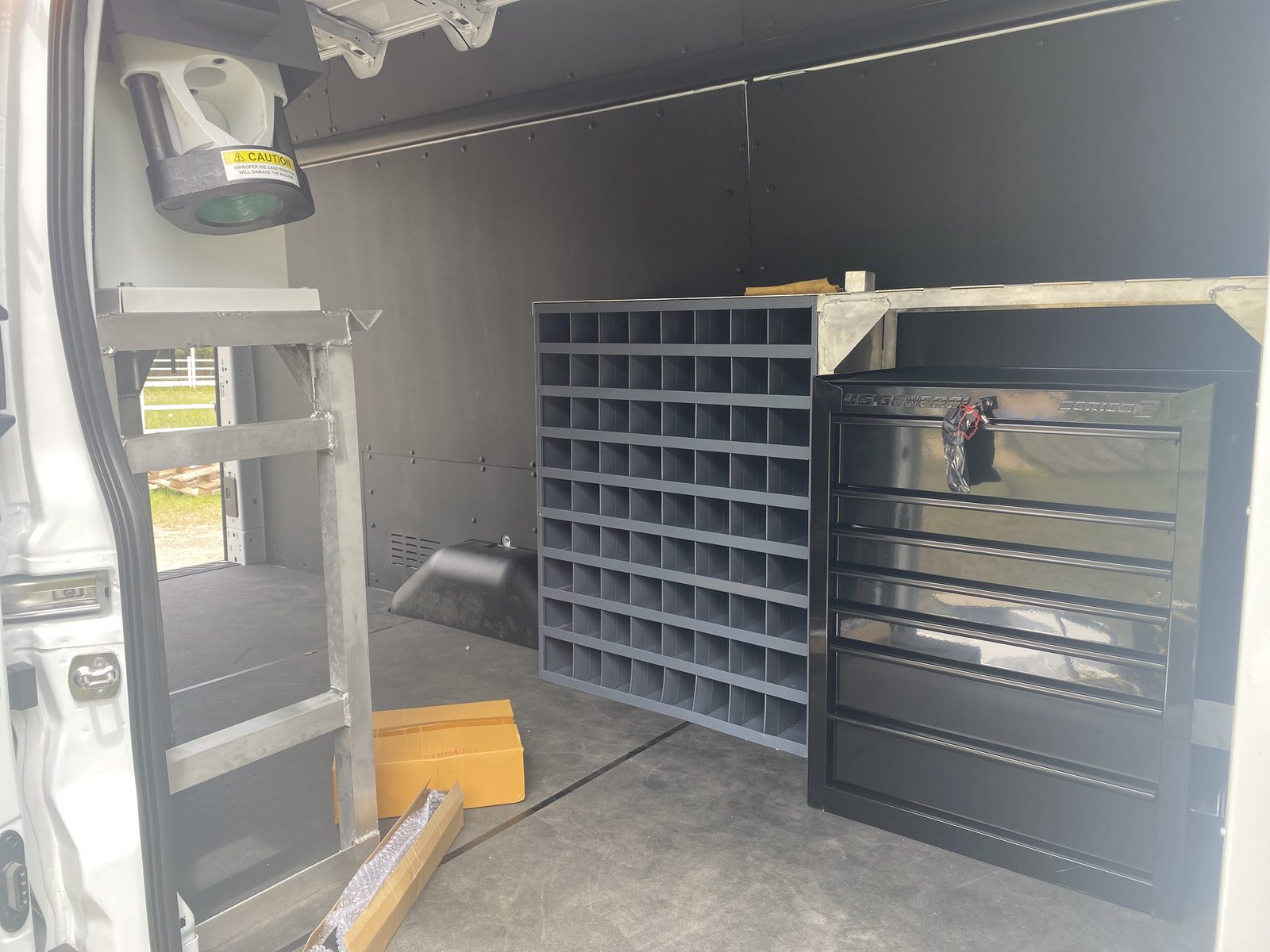 Full interior van upfitting, dual shelving layout from rear