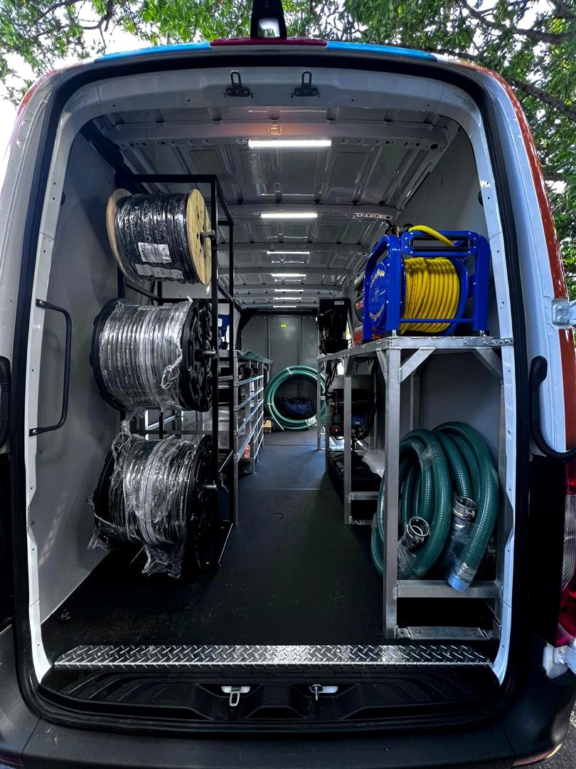 Finished van interior, rear view of completed custom steel shelving system, Fine Edge Industries