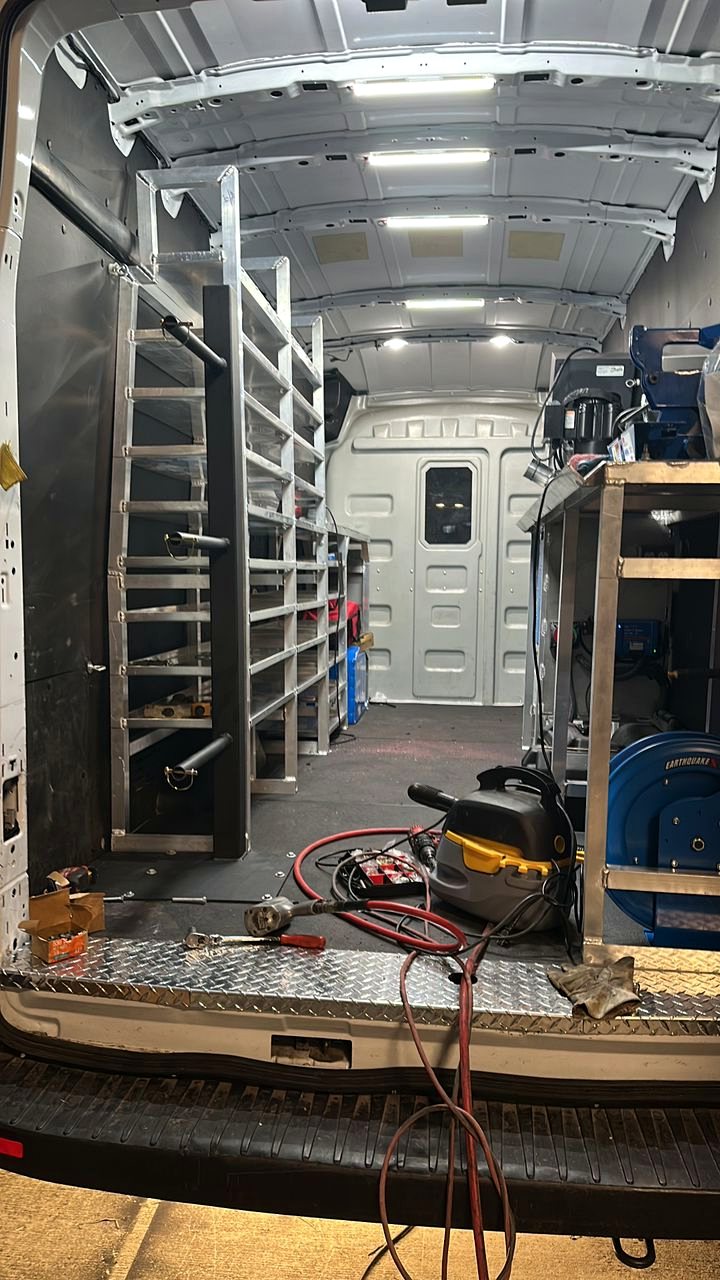 Custom steel shelving system being fabricated and fitted, van upfitting in progress, Fine Edge Industries