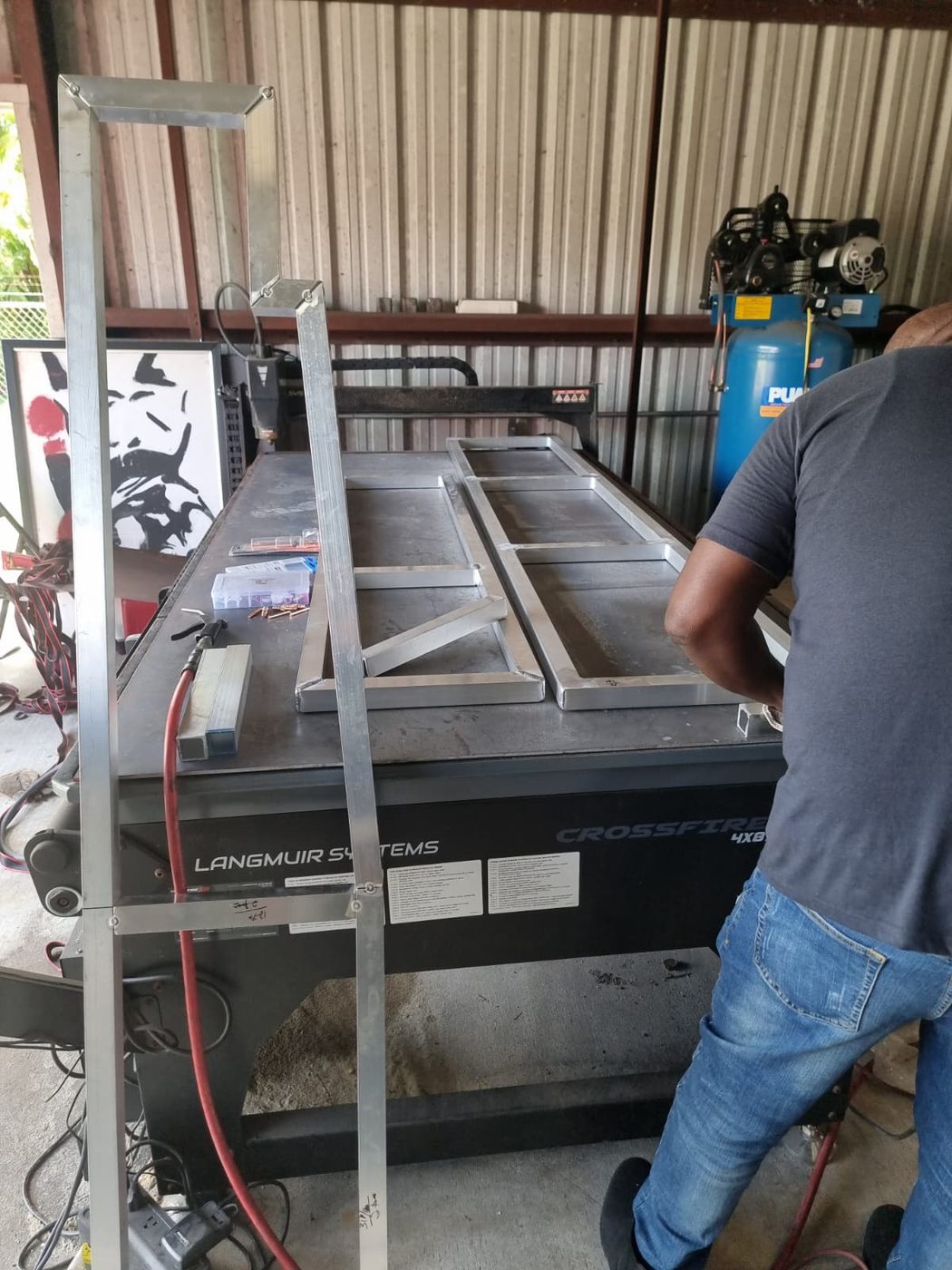CNC plasma cutting steel at the Fine Edge Industries fabrication shop