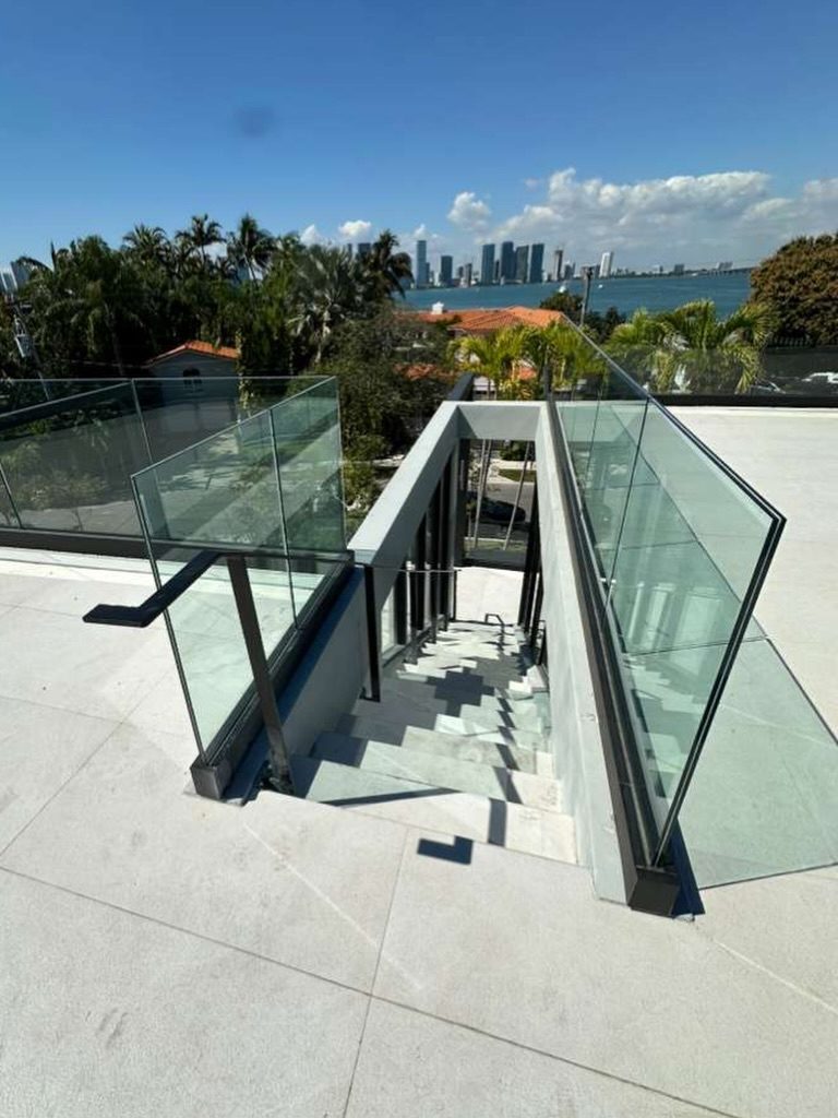 Stainless steel balustrade fabricated by Fine Edge Industries for a high-rise terrace overlooking the skyline