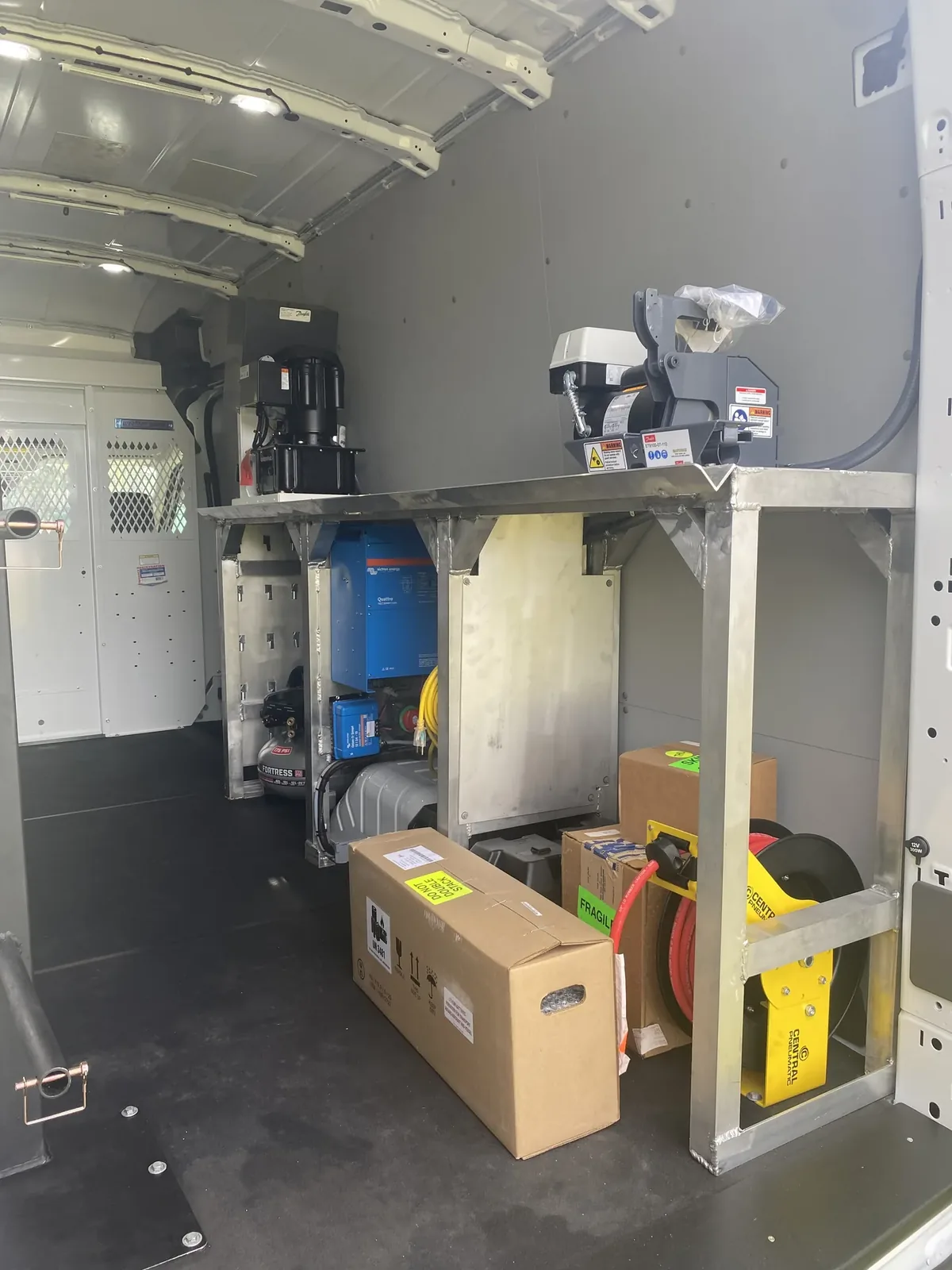 Custom X-brace van shelving system with storage cabinet